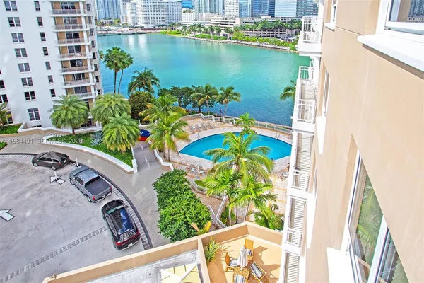 a view of a lake with a floor to ceiling window next to a building