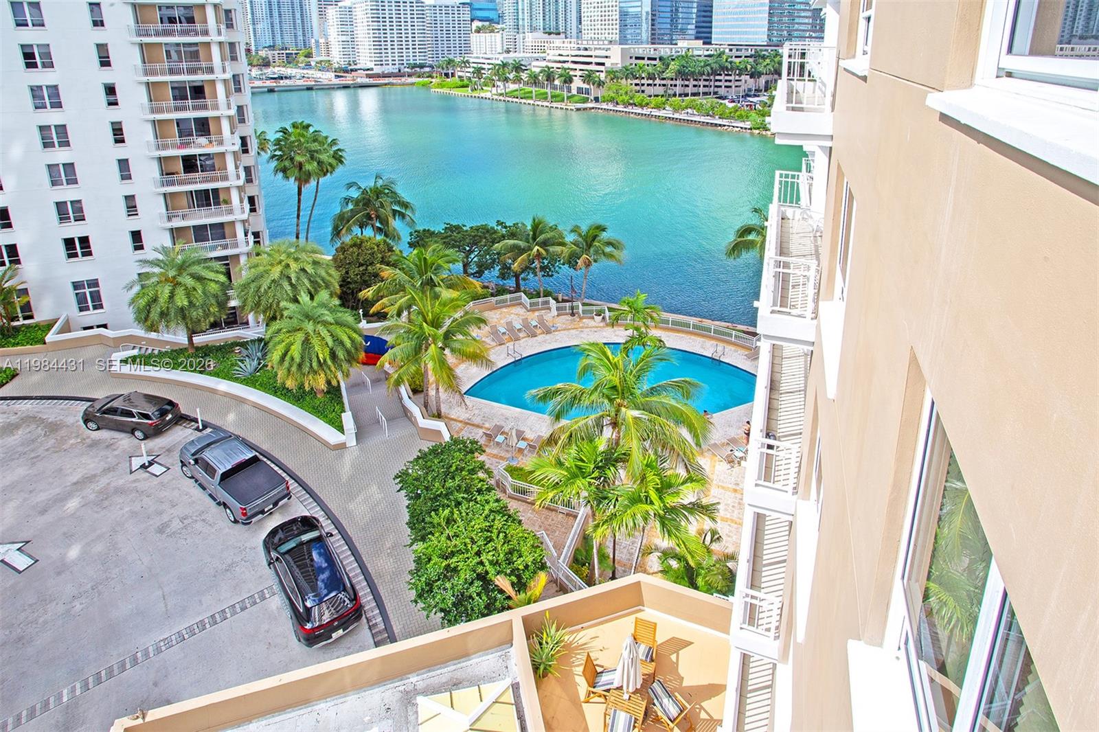 801 Brickell Key Boulevard, Unit 907 Miami, FL 33131 - Photo 2 of 53 a view of a lake with a floor to ceiling window next to a building
