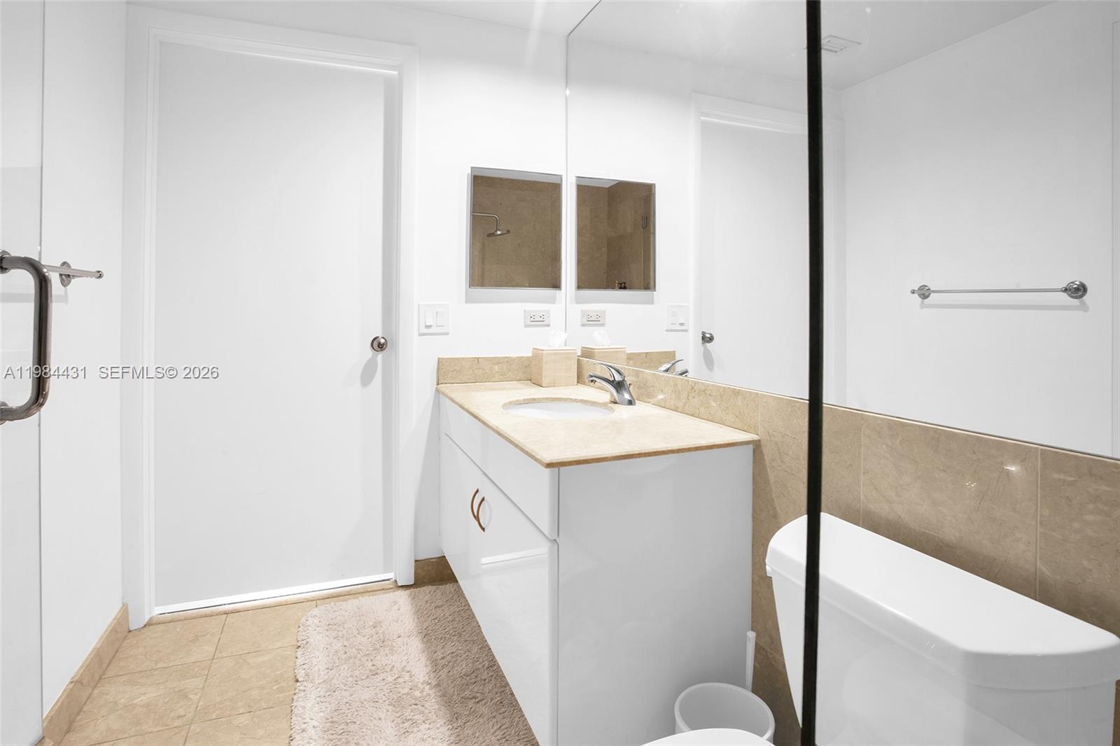 801 Brickell Key Boulevard, Unit 907 Miami, FL 33131 - Photo 31 of 53 a bathroom with a sink and a mirror