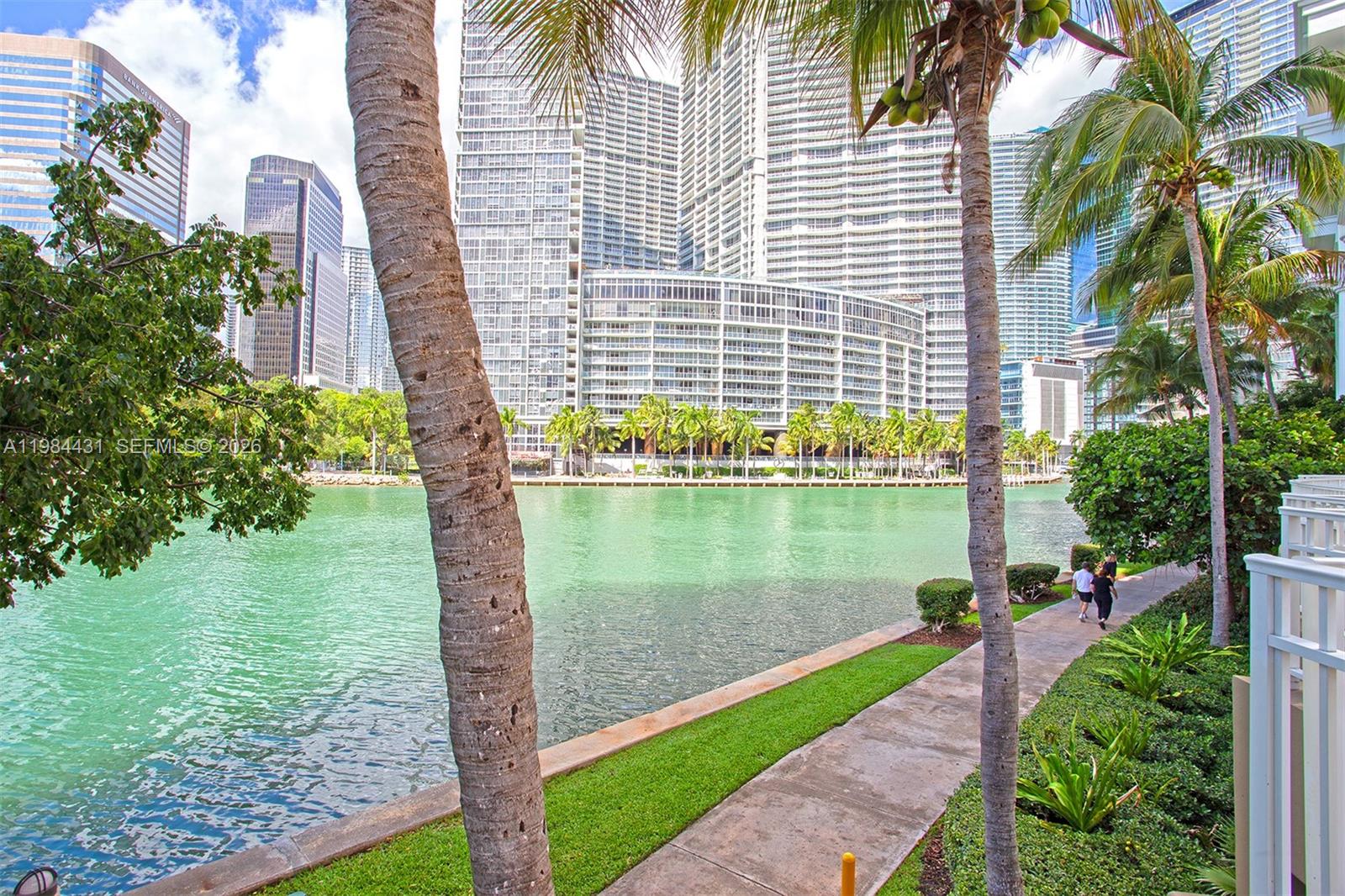 801 Brickell Key Boulevard, Unit 907 Miami, FL 33131 - Photo 38 of 53 a lake view with a garden
