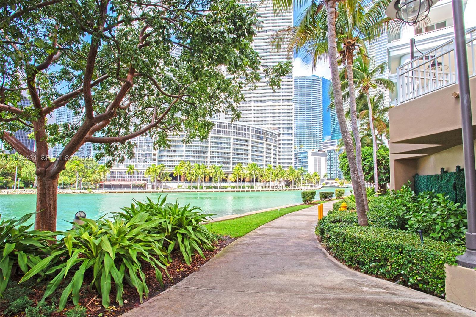 801 Brickell Key Boulevard, Unit 907 Miami, FL 33131 - Photo 43 of 53 a view of a swimming pool with a patio and a yard