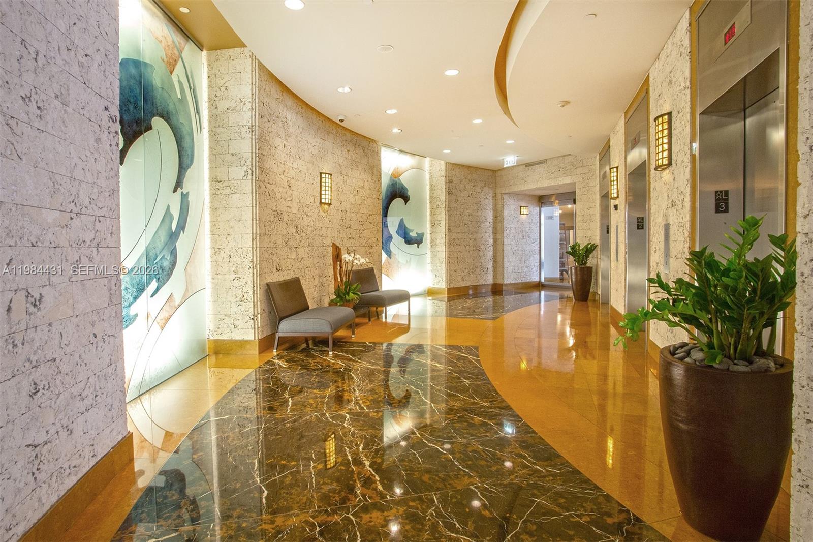 801 Brickell Key Boulevard, Unit 907 Miami, FL 33131 - Photo 49 of 53 a lobby with entryway and wooden floor