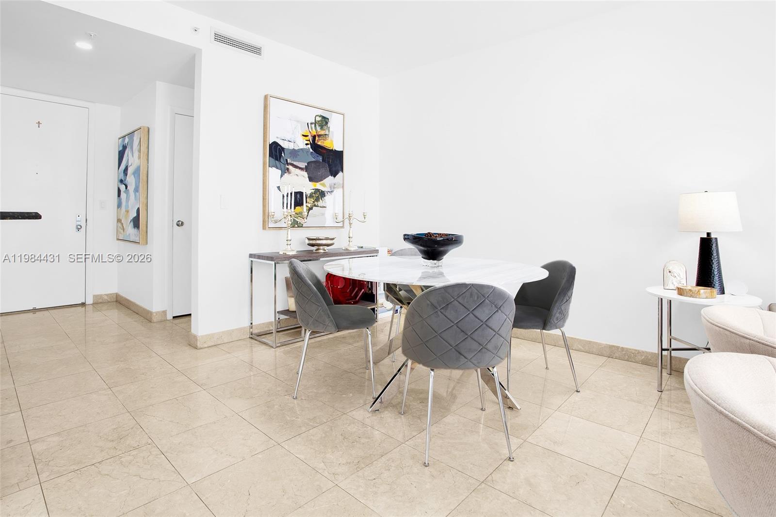801 Brickell Key Boulevard, Unit 907 Miami, FL 33131 - Photo 5 of 53 a view of a dining room with furniture and wooden floor