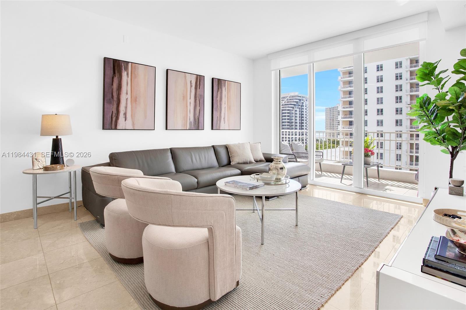 801 Brickell Key Boulevard, Unit 907 Miami, FL 33131 - Photo 6 of 53 a living room with furniture and a large window