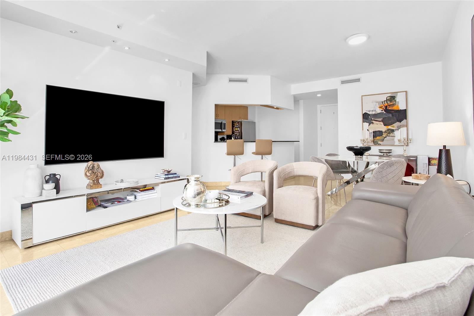 801 Brickell Key Boulevard, Unit 907 Miami, FL 33131 - Photo 9 of 53 a living room with furniture and a flat screen tv