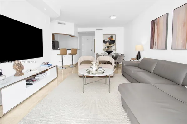 a living room with furniture and a flat screen tv