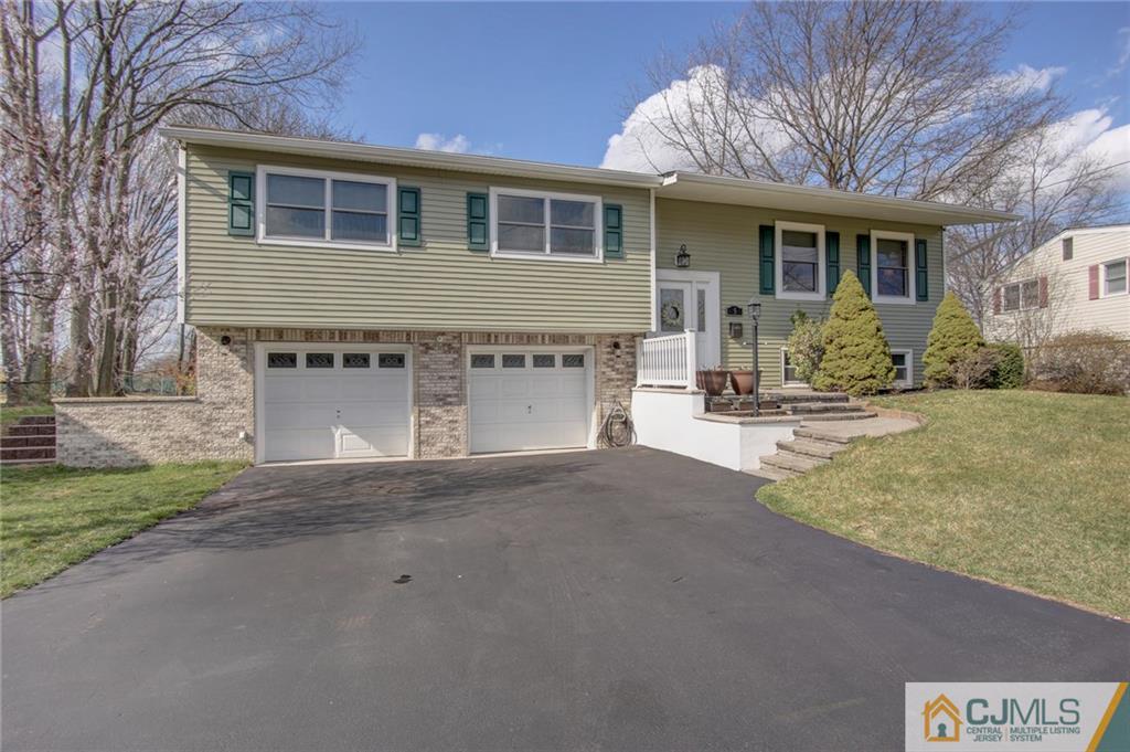 5 McEvoy Road Edison, NJ 08837 - Photo 1 of 22 a front view of a house with a yard and garage