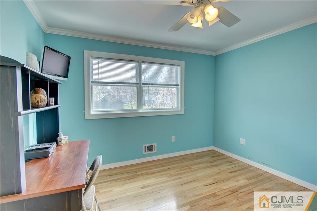 5 McEvoy Road Edison, NJ 08837 - Photo 11 of 22 a room with window and wooden floor