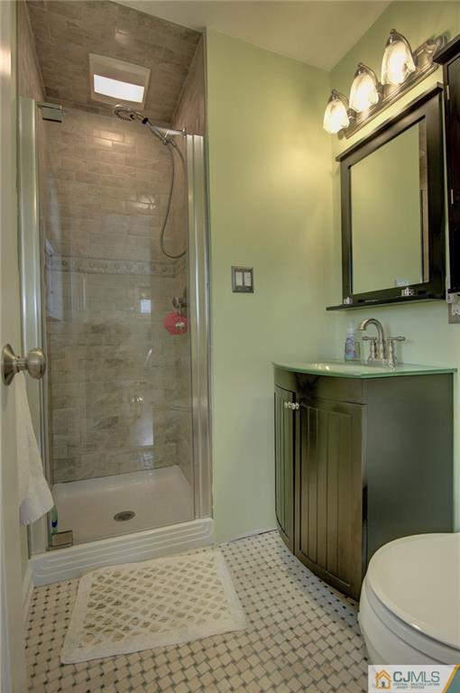 5 McEvoy Road Edison, NJ 08837 - Photo 14 of 22 a bathroom with a toilet a sink and mirror