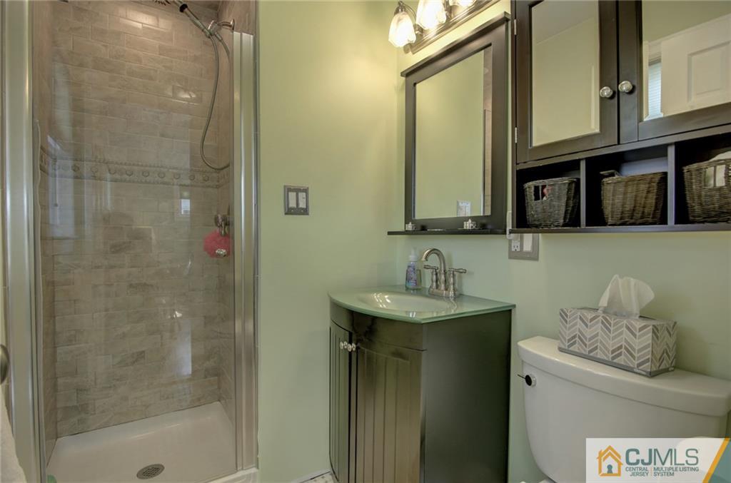 5 McEvoy Road Edison, NJ 08837 - Photo 15 of 22 a bathroom with a sink a vanity and a mirror