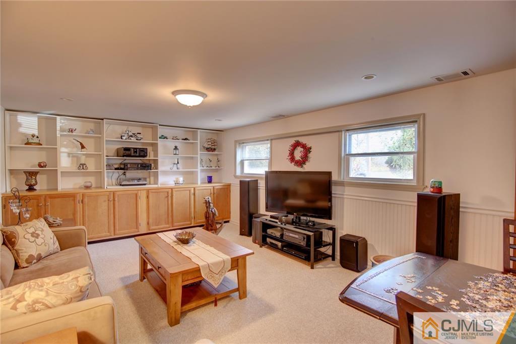 5 McEvoy Road Edison, NJ 08837 - Photo 16 of 22 a living room with furniture and a flat screen tv