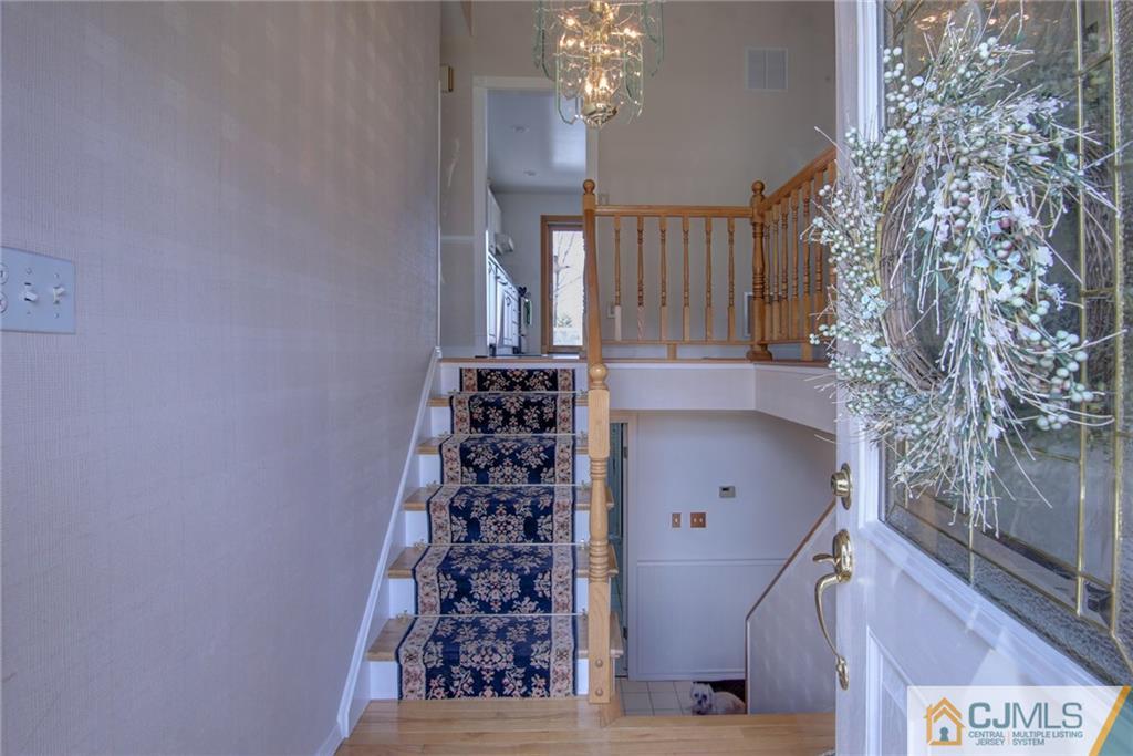 5 McEvoy Road Edison, NJ 08837 - Photo 3 of 22 a view of a hallway with windows and chandelier