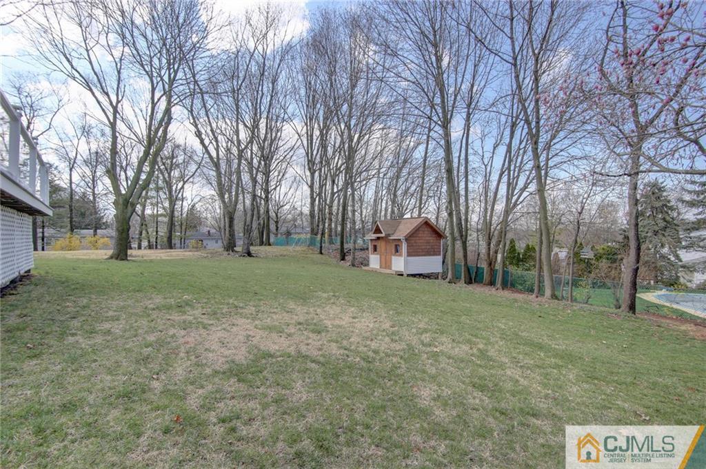 5 McEvoy Road Edison, NJ 08837 - Photo 21 of 22 a view of a tree in front of a house with a big yard