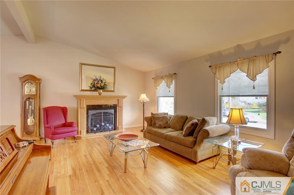 5 McEvoy Road Edison, NJ 08837 - Photo 6 of 22 a living room with furniture a fireplace and a table