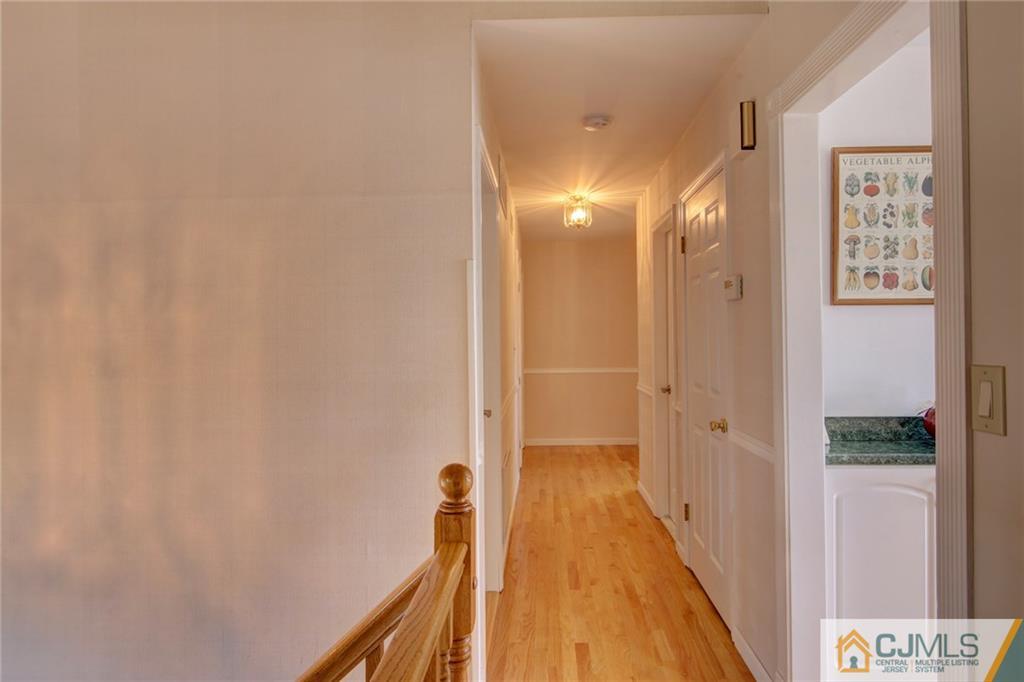5 McEvoy Road Edison, NJ 08837 - Photo 9 of 22 a view of a hallway with wooden floor and staircase
