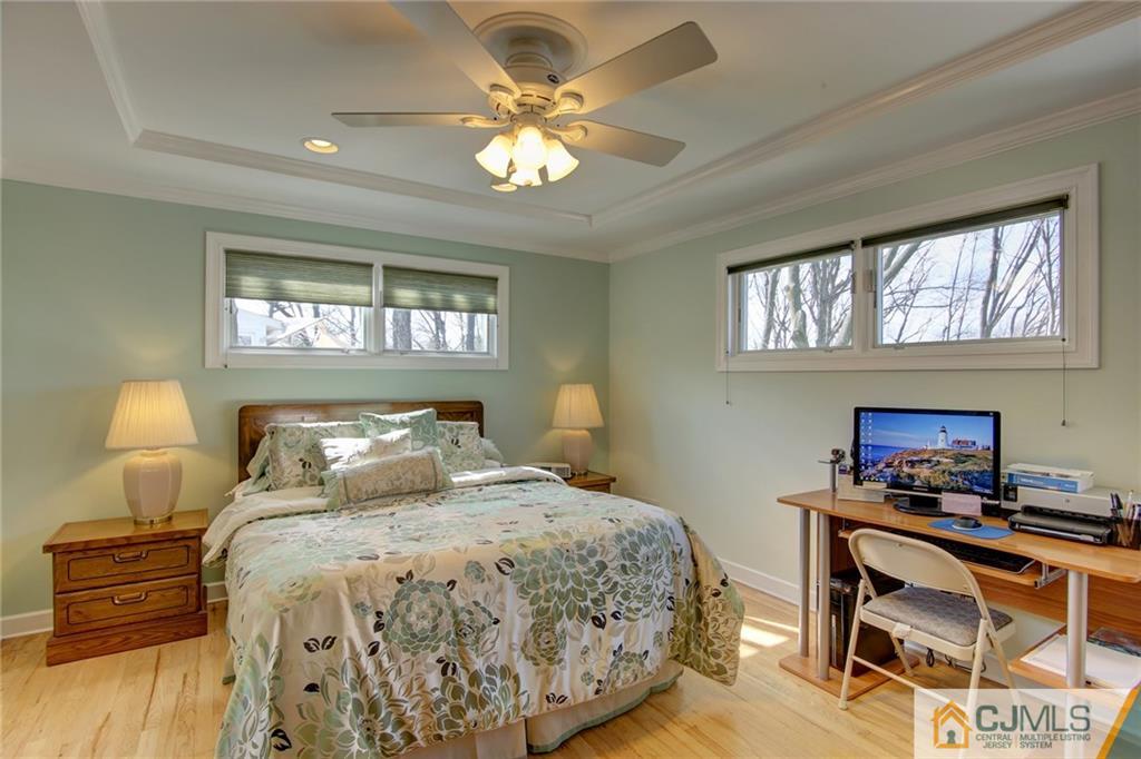 5 McEvoy Road Edison, NJ 08837 - Photo 10 of 22 a bedroom with a bed and a chandelier