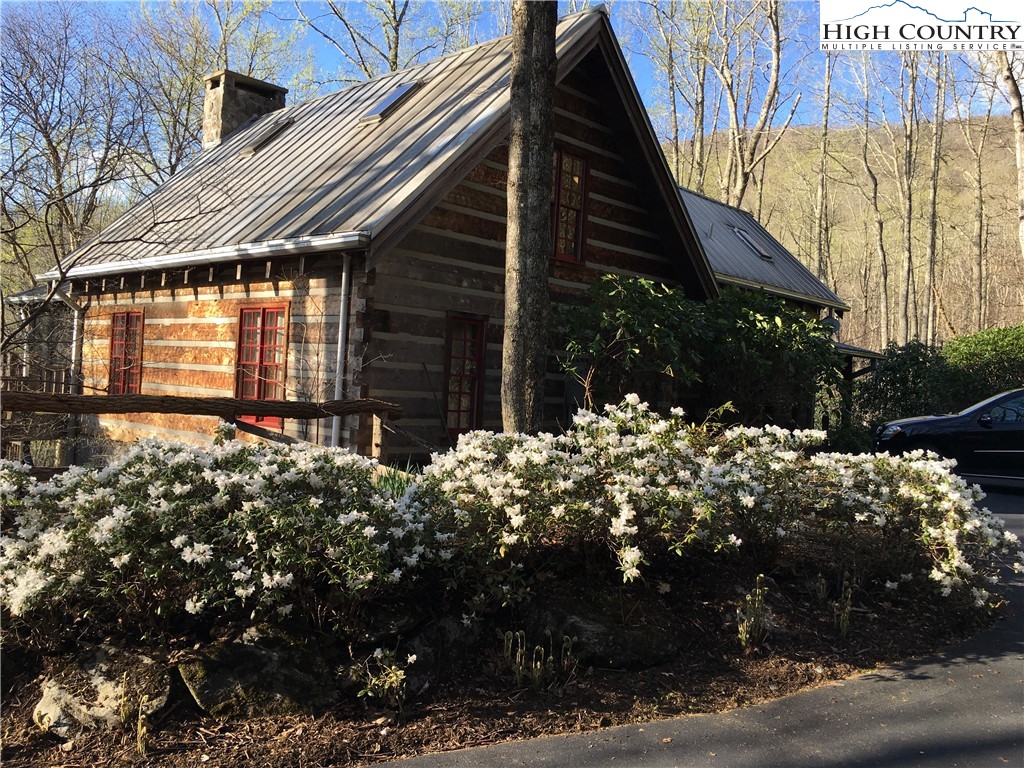a view of a house with a yard and pathway