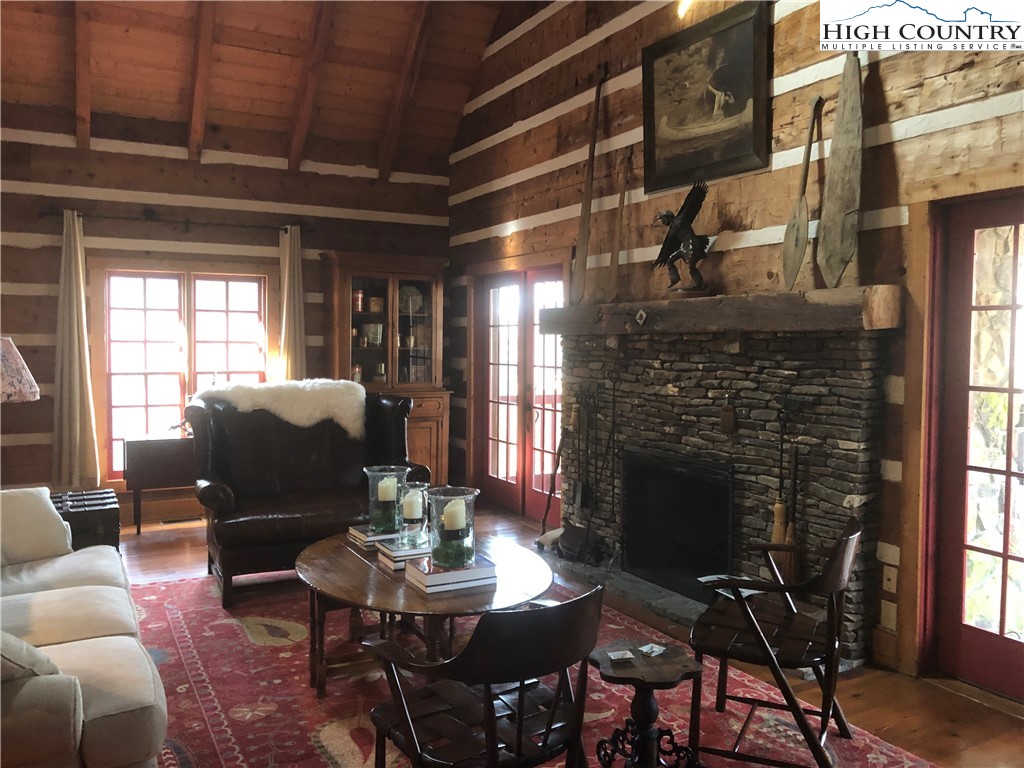 127-129 Rim Rock Gorge Road Blowing Rock, NC 28605 - Photo 2 of 15 a living room with furniture a window and a fireplace