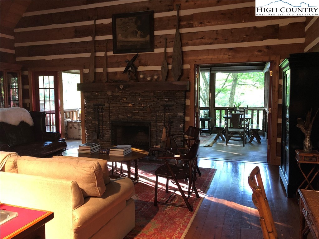 127-129 Rim Rock Gorge Road Blowing Rock, NC 28605 - Photo 8 of 15 a living room with furniture a flat screen tv and a fireplace