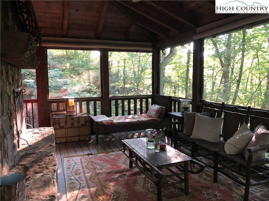 127-129 Rim Rock Gorge Road Blowing Rock, NC 28605 - Photo 9 of 15 a living room with furniture and a floor to ceiling window