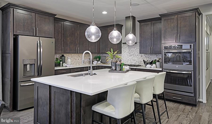 19004 Amesbury Road Hagerstown, MD 21742 - Photo 16 of 16 a kitchen with a table and refrigerator