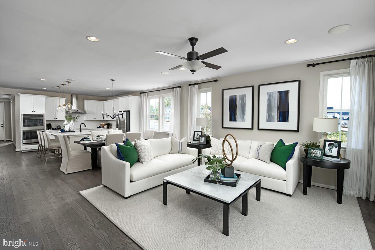 19004 Amesbury Road Hagerstown, MD 21742 - Photo 2 of 16 a living room with furniture kitchen view and a potted plant