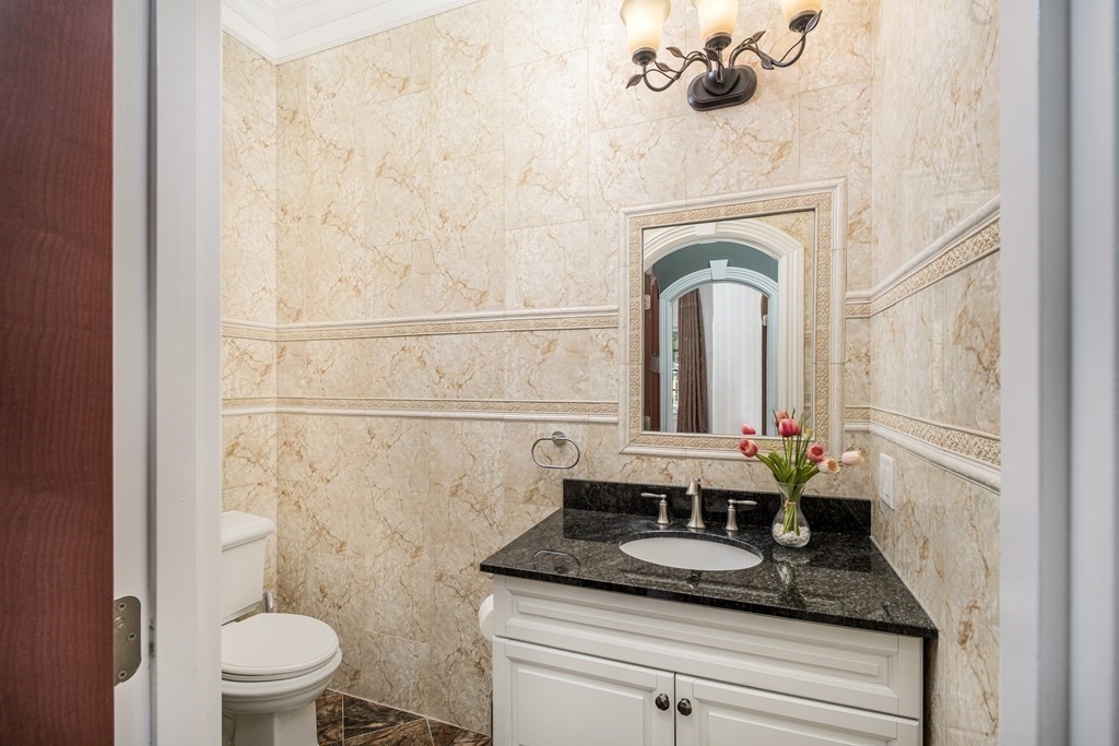 7 Evergreen Avenue Weston, MA 02493 - Photo 12 of 42 a bathroom with a granite countertop sink a toilet and a mirror
