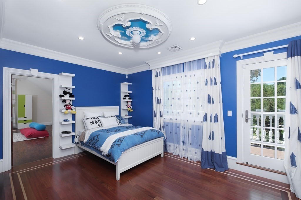 7 Evergreen Avenue Weston, MA 02493 - Photo 17 of 42 a bedroom with a bed and a chandelier
