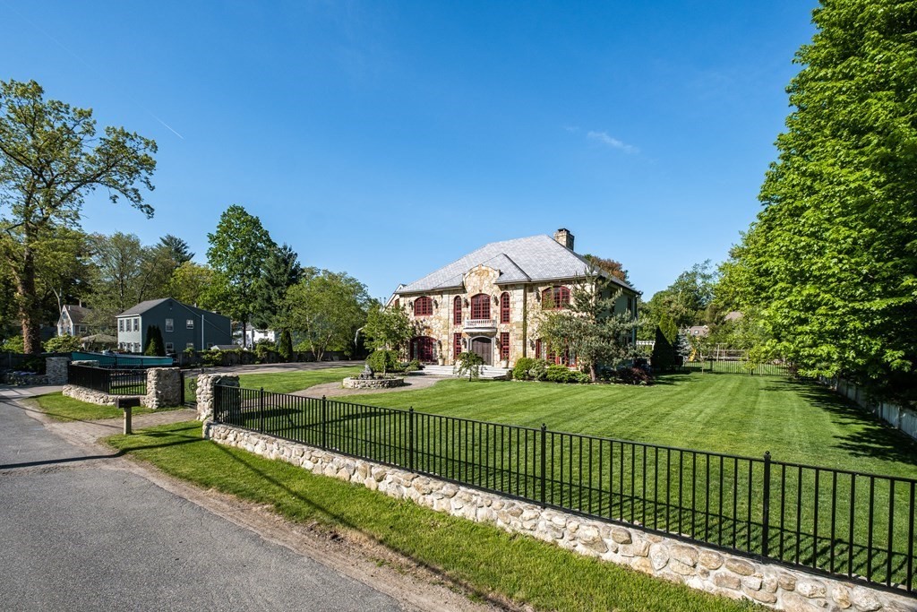 7 Evergreen Avenue Weston, MA 02493 - Photo 2 of 42 a front view of a house with a yard