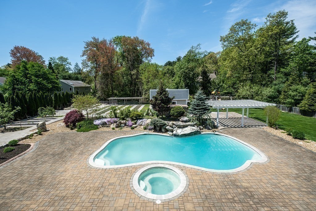 7 Evergreen Avenue Weston, MA 02493 - Photo 21 of 42 a view of a swimming pool and lounge chairs