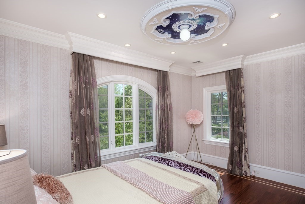 7 Evergreen Avenue Weston, MA 02493 - Photo 23 of 42 a bedroom with a bed and a chandelier