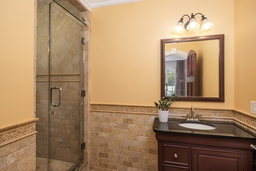 7 Evergreen Avenue Weston, MA 02493 - Photo 24 of 42 a bathroom with a sink a mirror and shower