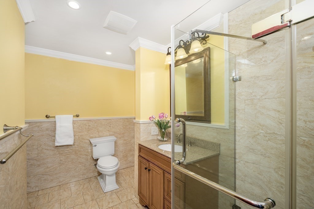 7 Evergreen Avenue Weston, MA 02493 - Photo 27 of 42 a bathroom with a granite countertop sink a toilet and shower