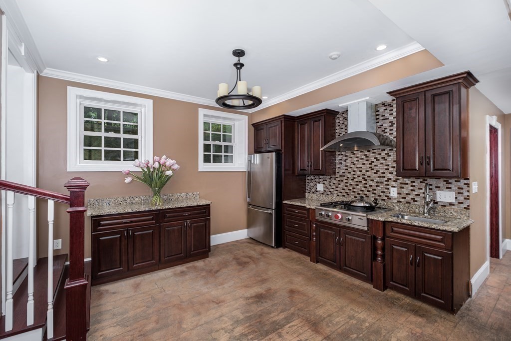 7 Evergreen Avenue Weston, MA 02493 - Photo 29 of 42 a kitchen with stainless steel appliances granite countertop a stove and a refrigerator