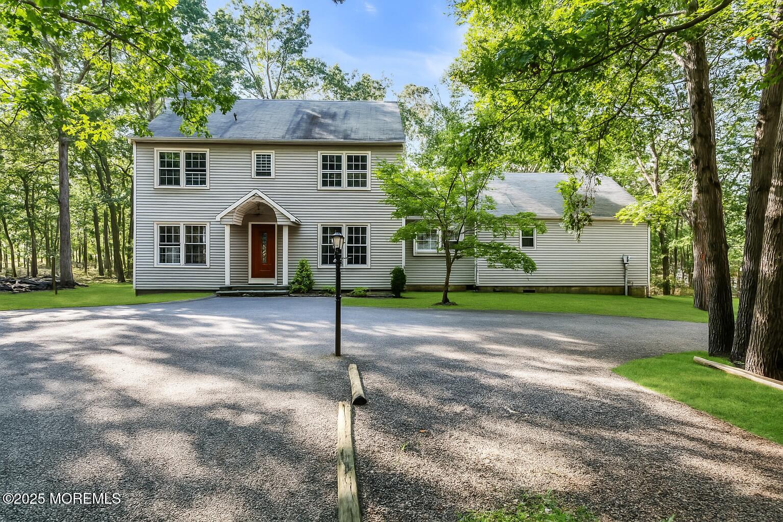 426 Basso Street Jackson, NJ 08527 - Photo 2 of 11 a front view of a house with a garden