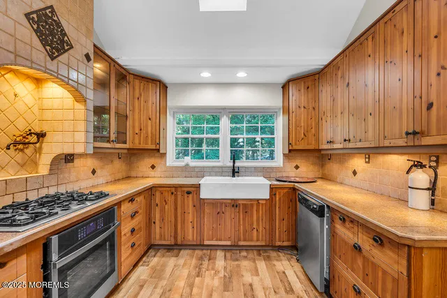 a kitchen with a sink stove and cabinets