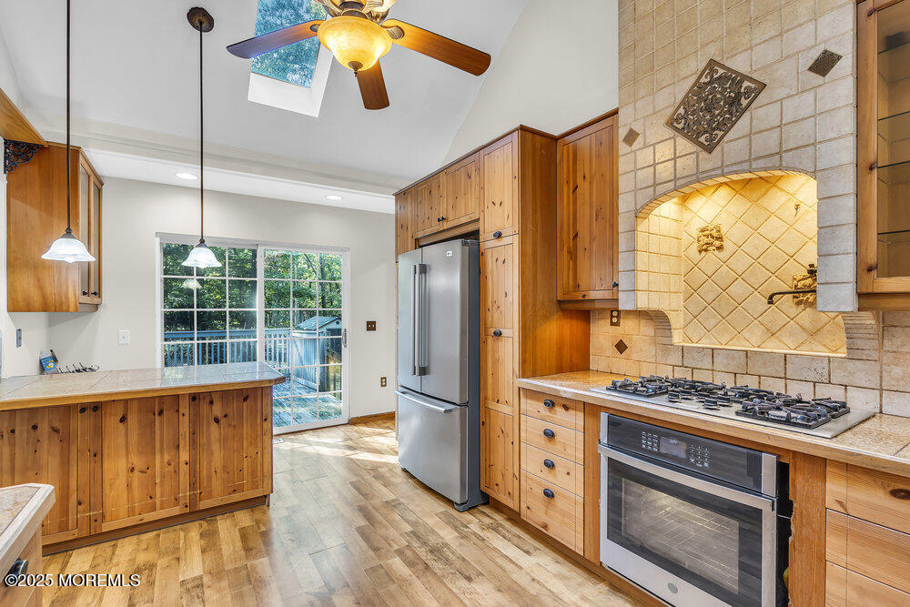 426 Basso Street Jackson, NJ 08527 - Photo 5 of 11 a kitchen with stainless steel appliances granite countertop a refrigerator and a stove top oven