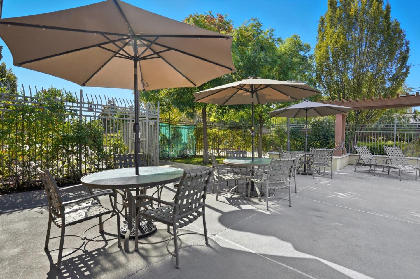 2881 Meridian Avenue, Unit 217 San Jose, CA 95124 - Photo 34 of 39 a view of patio with chairs and table under an umbrella