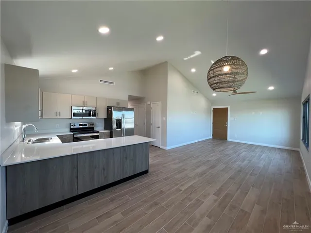 a kitchen with stainless steel appliances a refrigerator sink and stove