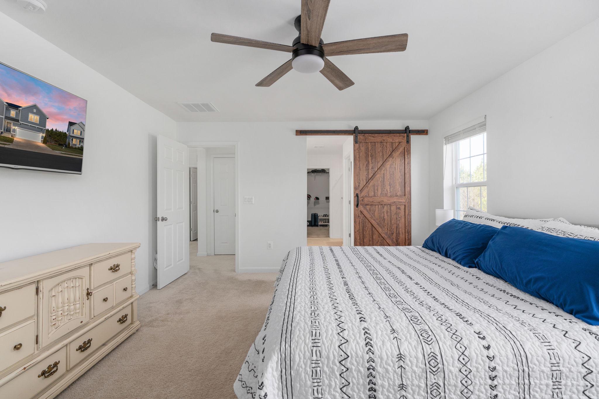 6371 Pointer Lane King George, VA 22485 - Photo 24 of 38 a bedroom with a bed and a flat tv screen on the dresser