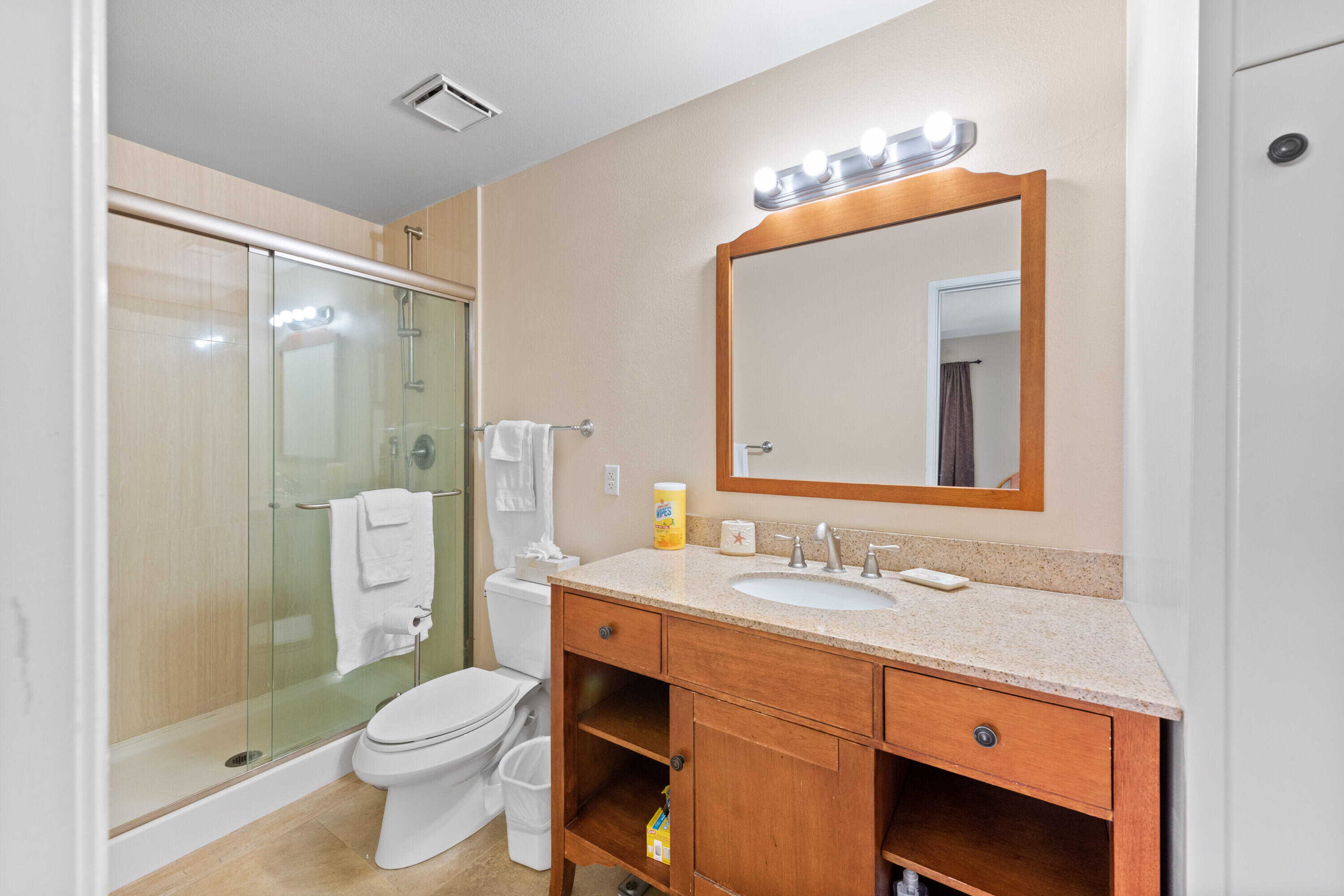 1150 East Amado Road, Unit 20C2 Palm Springs, CA 92262 - Photo 11 of 14 a bathroom with a sink a toilet a large mirror and shower