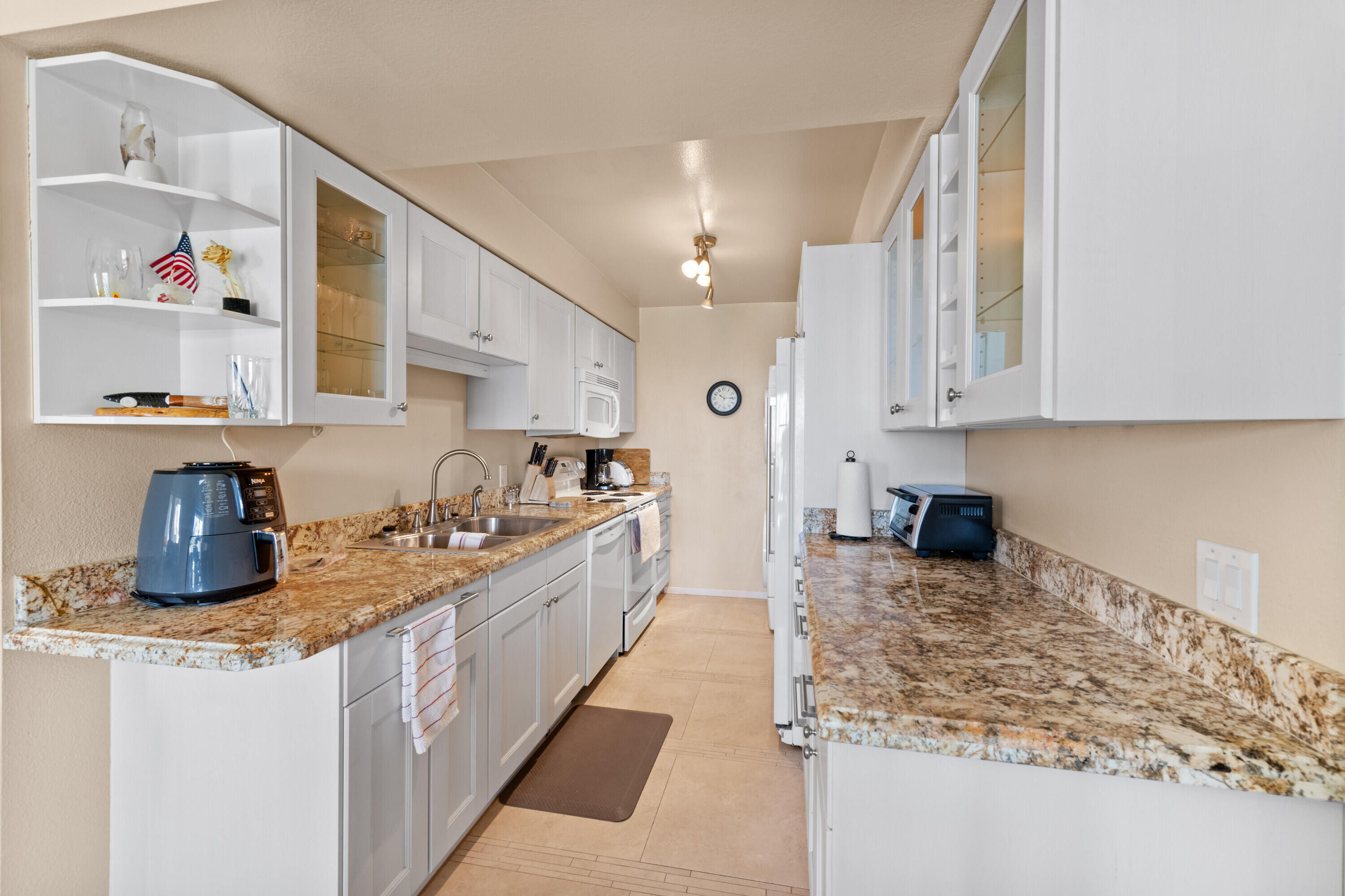 1150 East Amado Road, Unit 20C2 Palm Springs, CA 92262 - Photo 14 of 14 a kitchen with sink cabinets and counter top space