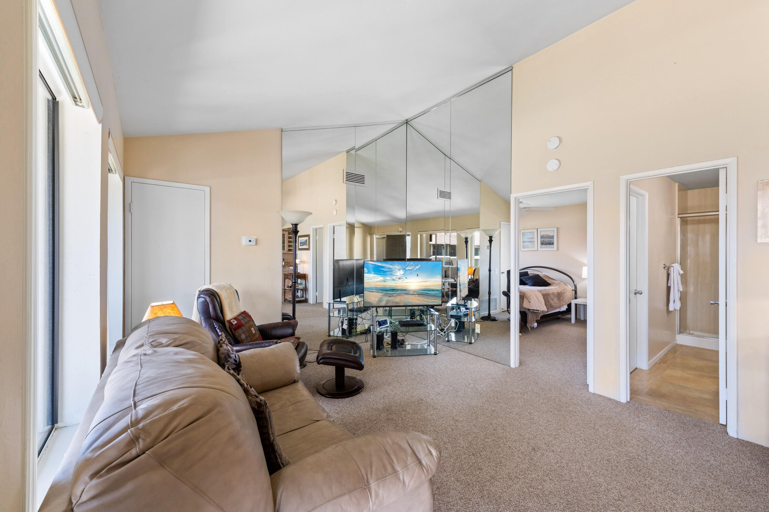 1150 East Amado Road, Unit 20C2 Palm Springs, CA 92262 - Photo 7 of 14 a living room with furniture a couch and a large window