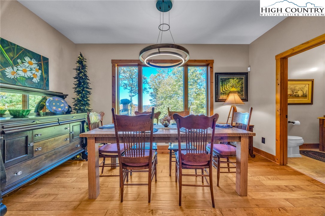 2650 Carson Woods Road Laurel Springs, NC 28644 - Photo 5 of 50 a view of a dining room with furniture window and wooden floor