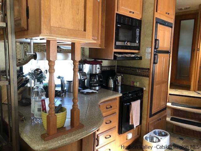 39 Travis Boulevard Catskill, NY 12414 - Photo 11 of 20 a kitchen with a refrigerator and a stove