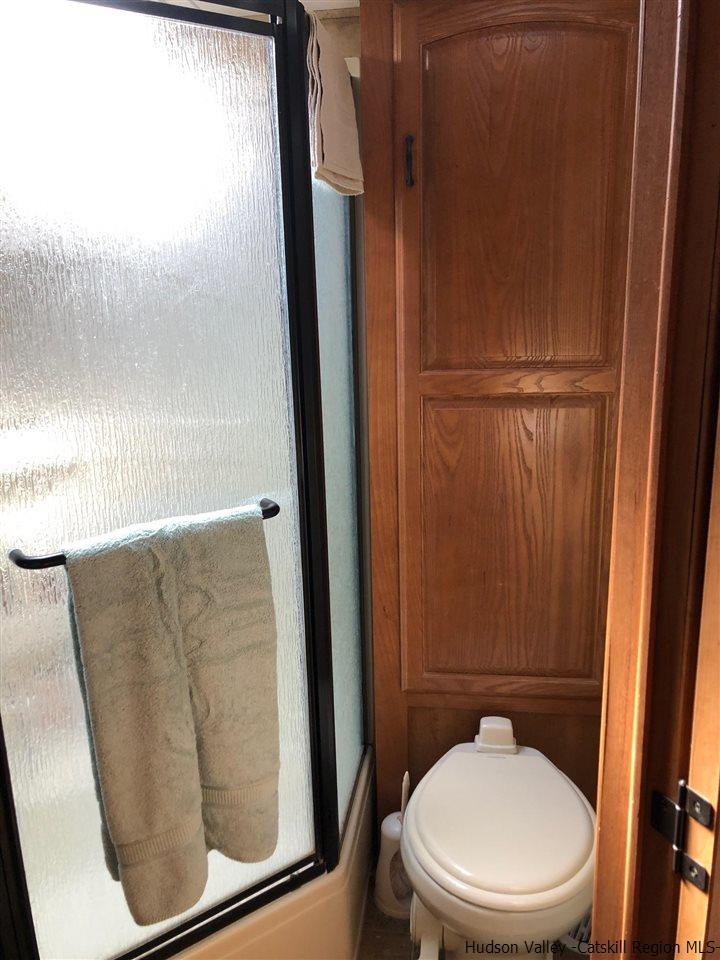 39 Travis Boulevard Catskill, NY 12414 - Photo 19 of 20 a bathroom with a toilet and a shower