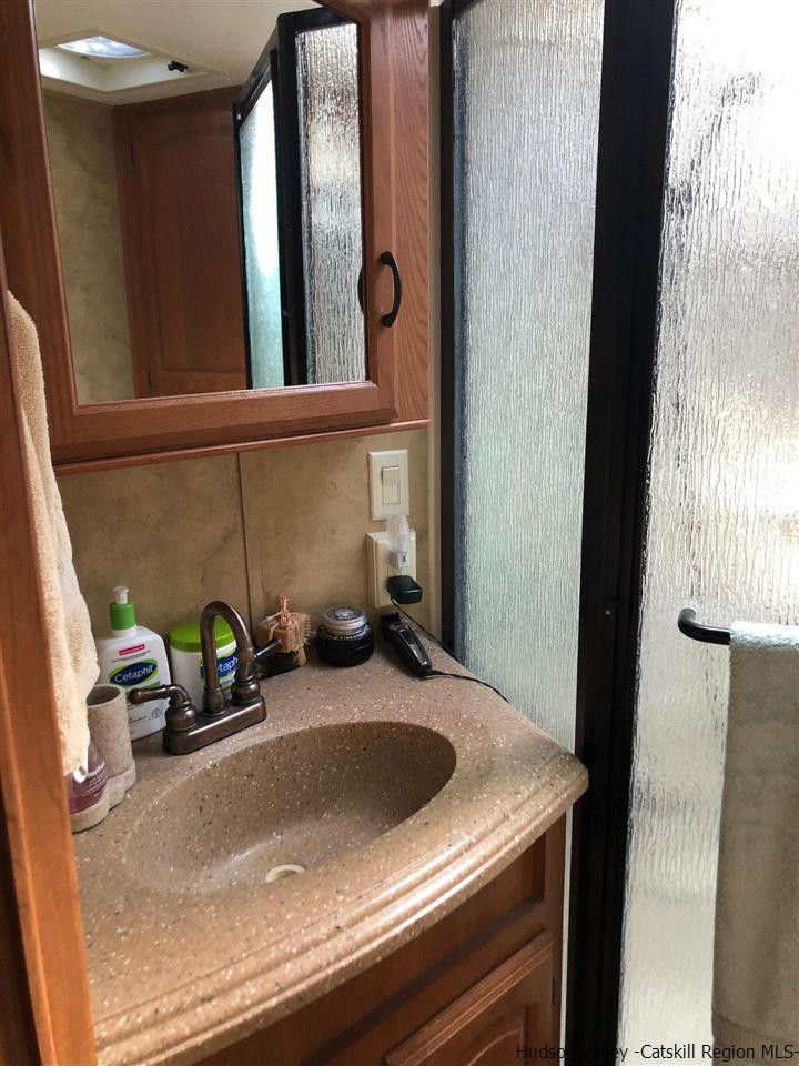 39 Travis Boulevard Catskill, NY 12414 - Photo 20 of 20 a bathroom with a sink and a mirror