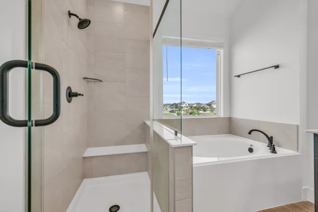 a bathroom with a tub and a shower