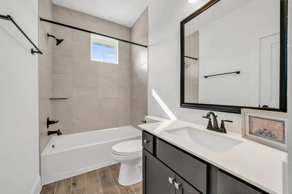 a bathroom with a sink toilet tub and shower