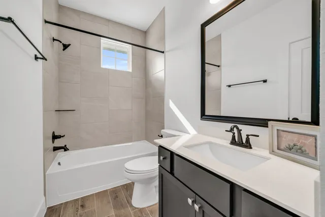a bathroom with a sink toilet tub and shower